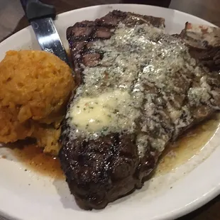 Porterhouse steak with garlic butter. Side order of cheesy hash browns.