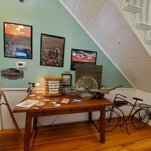 a wooden table with books and a bicycle