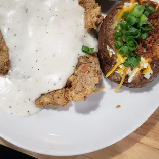 Chicken Fried Steak, brocolini rice, and loaded baked potato