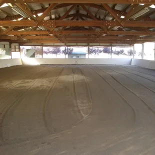 Indoor arena 80' x 140' w/ insulated roof, rubber / sand footing, mirrored wall, lighting, watered &amp; groomed daily.