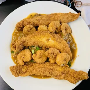 Fried catfish shrimp and crawfish etouffee  over dirty rice