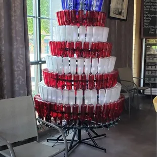 a wine tower made out of red, white and blue wine glasses