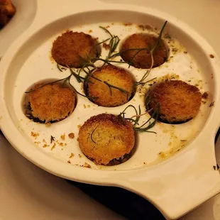 Escargot topped with toasted coins of bread