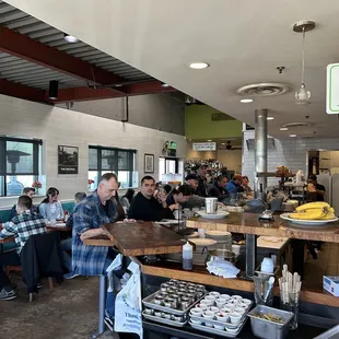people sitting at tables and eating