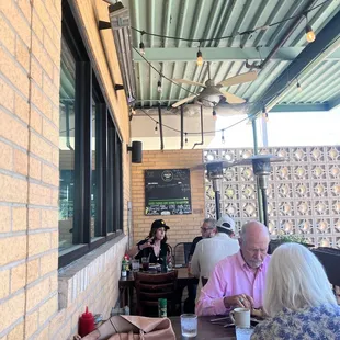 people sitting at tables outside
