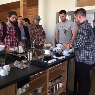 a group of men preparing coffee