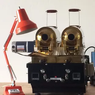 two coffee grinders and a red lamp