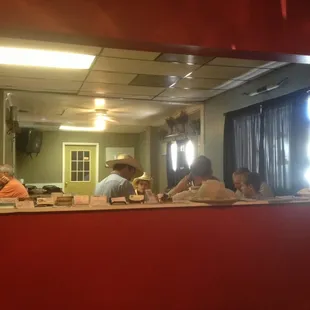a group of people sitting at a counter