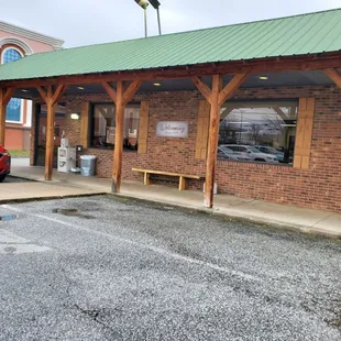 a red car parked in front of a brick building