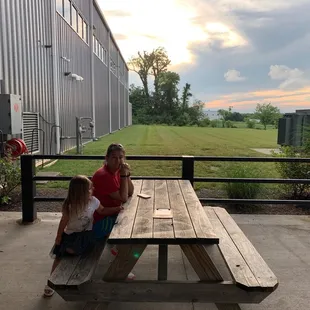 two girls sitting at a picnic table