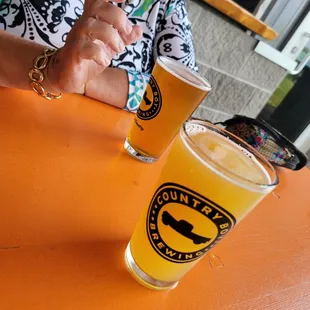 Beer Garden Tables with Witness the Citrus NEIPA and Cliff Jumper IPA. Each table has a QR Code to scan booth beer and food.