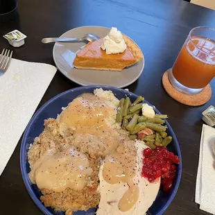 a plate of food and a glass of orange juice