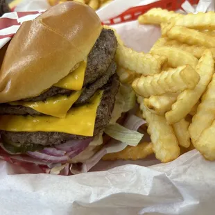 Triple patty cheeseburger with fries.