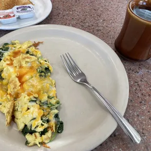 Breakfast spinach scramble full of yumminess and a mug of tea