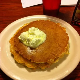 a stack of pancakes with butter and syrup