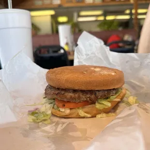 a hamburger with lettuce and tomato