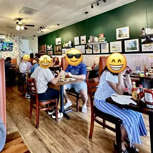 people sitting at tables with smiley faces on their faces