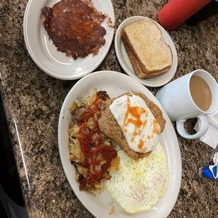 Country fried steak with a side of corn beef hash