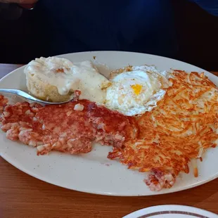 Corned beef hash and eggs with a biscuit and gravy
