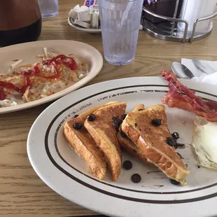 Chocolate chip French toast, bacon, hashbrown and an egg over easy.