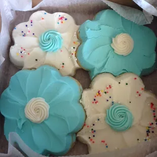 a box of decorated sugar cookies