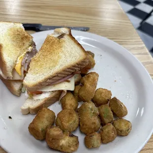 This is a club sandwich and I've already eaten half of fried okra.
