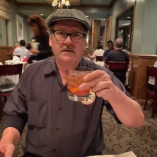 a man holding a drink