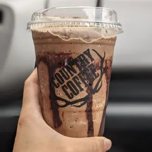 a hand holding a cup of coffee