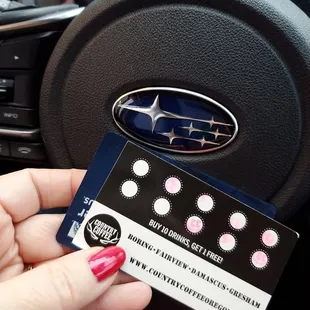 a person holding a business card in a car