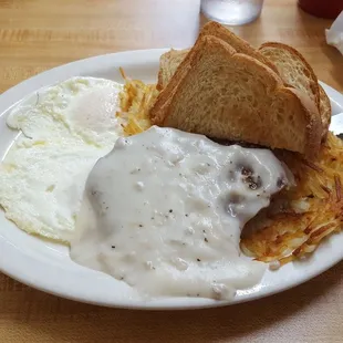 Chicken fried steak and eggs, with a single bite taken out of it because I almost forgot to take the pic before eating it.