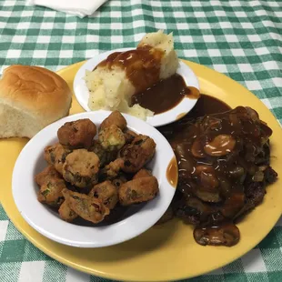 Hamburger Steak, fried okra, and mashed potatoes and gravy.