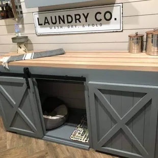 Custom made doggie kennel on one side and kitty litter storage on the other.