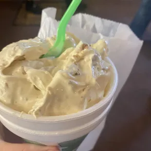 a hand holding a cup of cottage cheese