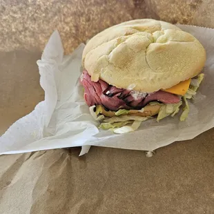 a roast beef sandwich with lettuce and cheese