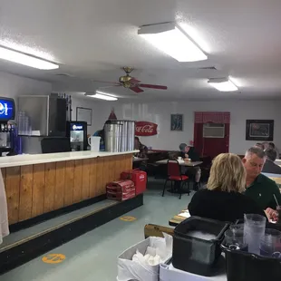 people sitting at tables in a diner