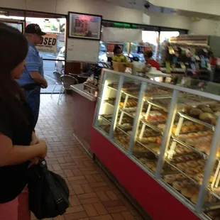 a woman standing in front of a display case