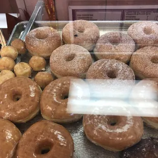 a variety of doughnuts in a display case