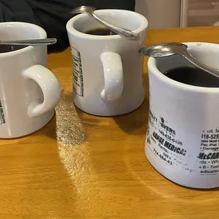 three coffee mugs on a table