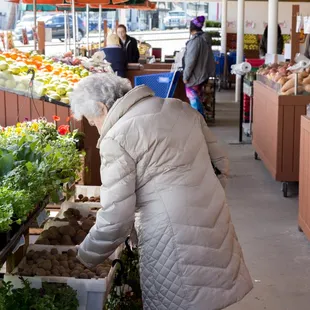 a woman shopping in a farmers market