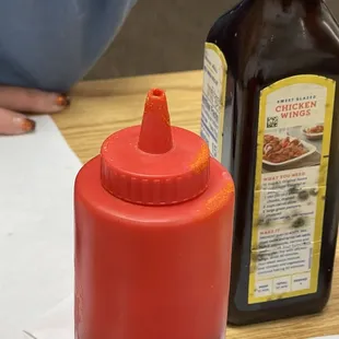 Old dry sauce down the lid. Mold spores on the steak sauce bottle behind it.