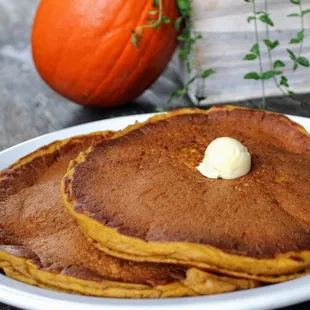 Our famous Pumpkin Pancakes! Served with fresh cranberry syrup and whipped butter.