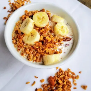 Housemade nut and seed granola, served with choice of milk and sliced banana.