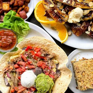 Breakfast spread of Tostada, Famous Banana French Toast, blueberry coffee cake, grilled homestyle potatoes.
