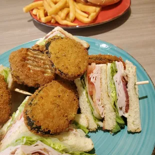 a plate of sandwiches and french fries