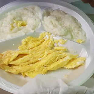 a plate of scrambled eggs, rice, and sausage