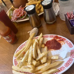 a plate of french fries with ketchup