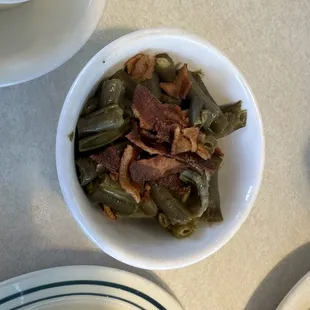 Green beans are super soggy and bacon beyond well done.