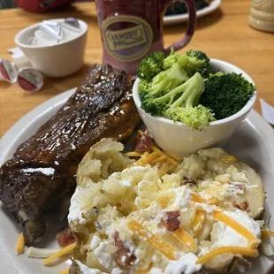 Ribs, broccoli and loaded baked potato