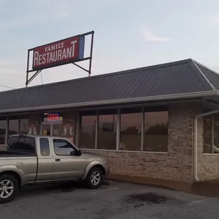 a pickup truck parked in front of the restaurant