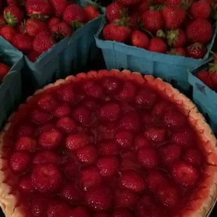 a strawberry pie and baskets of strawberries